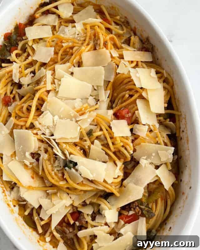 Baked spaghetti bolognese topped with shaved parmesan