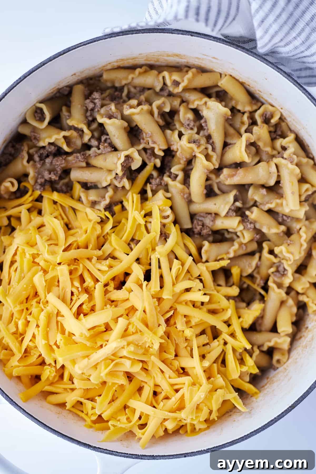 cooked one pot hamburger pasta topped with shredded cheese.