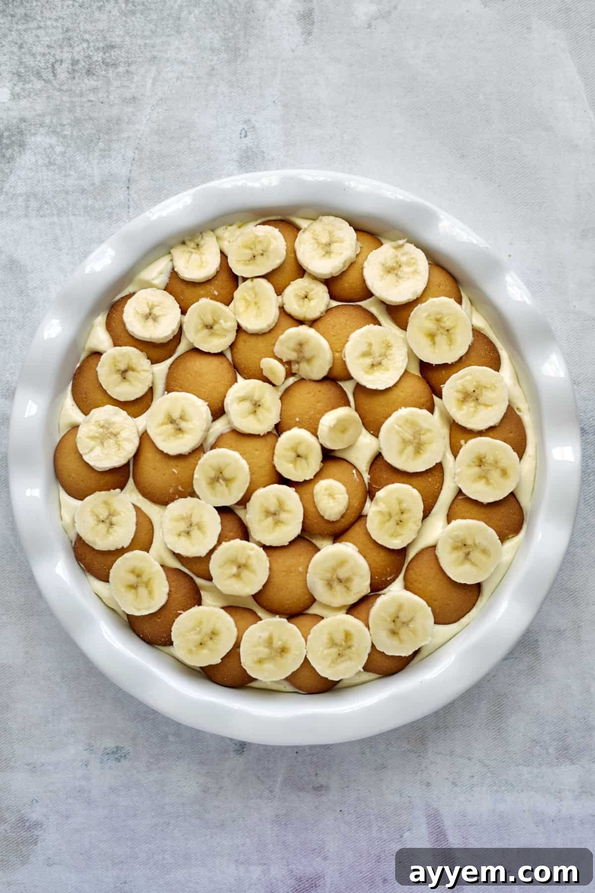 More Nilla wafers and banana slices arranged on top of the vanilla pudding for banana pudding.