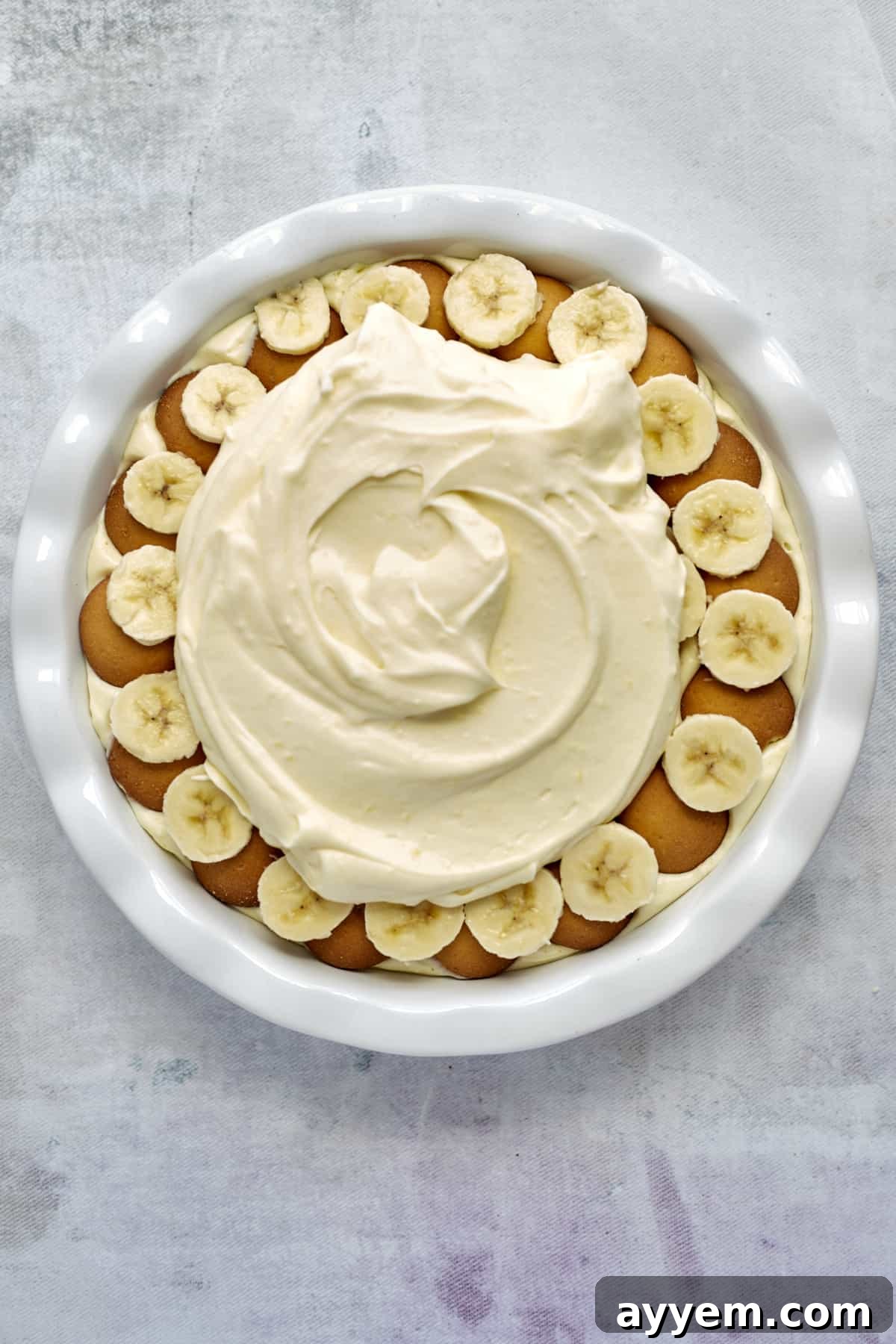 The second generous layer of vanilla pudding spread over the Nilla wafers and banana slices in a baking dish.