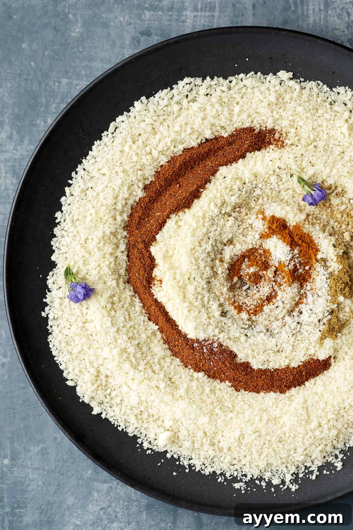 Various spices arranged on a surface, ready to create the breading for air fried tilapia.