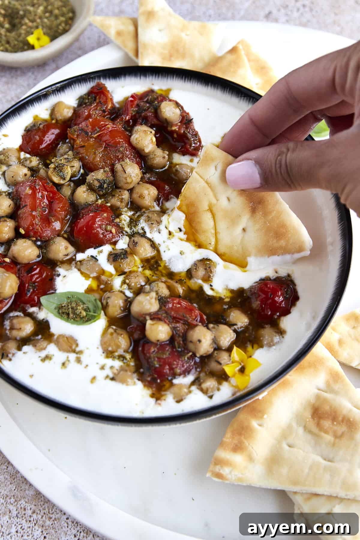 Close-up of Creamy Whipped Feta Dip with Roasted Tomatoes and Chickpeas, ready to be enjoyed.