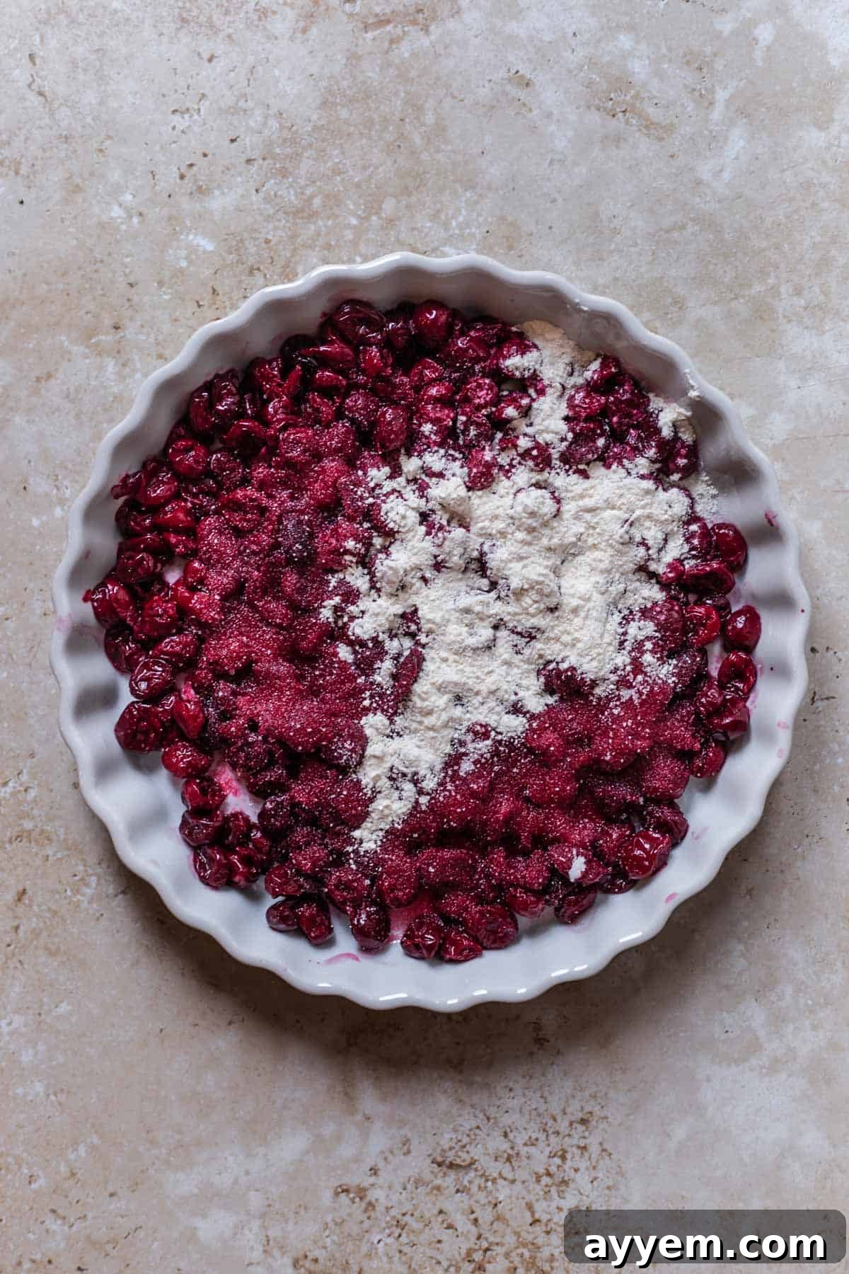 Vibrant red cherries, fresh or drained from a can, dusted lightly with sugar, ready for the crisp filling.