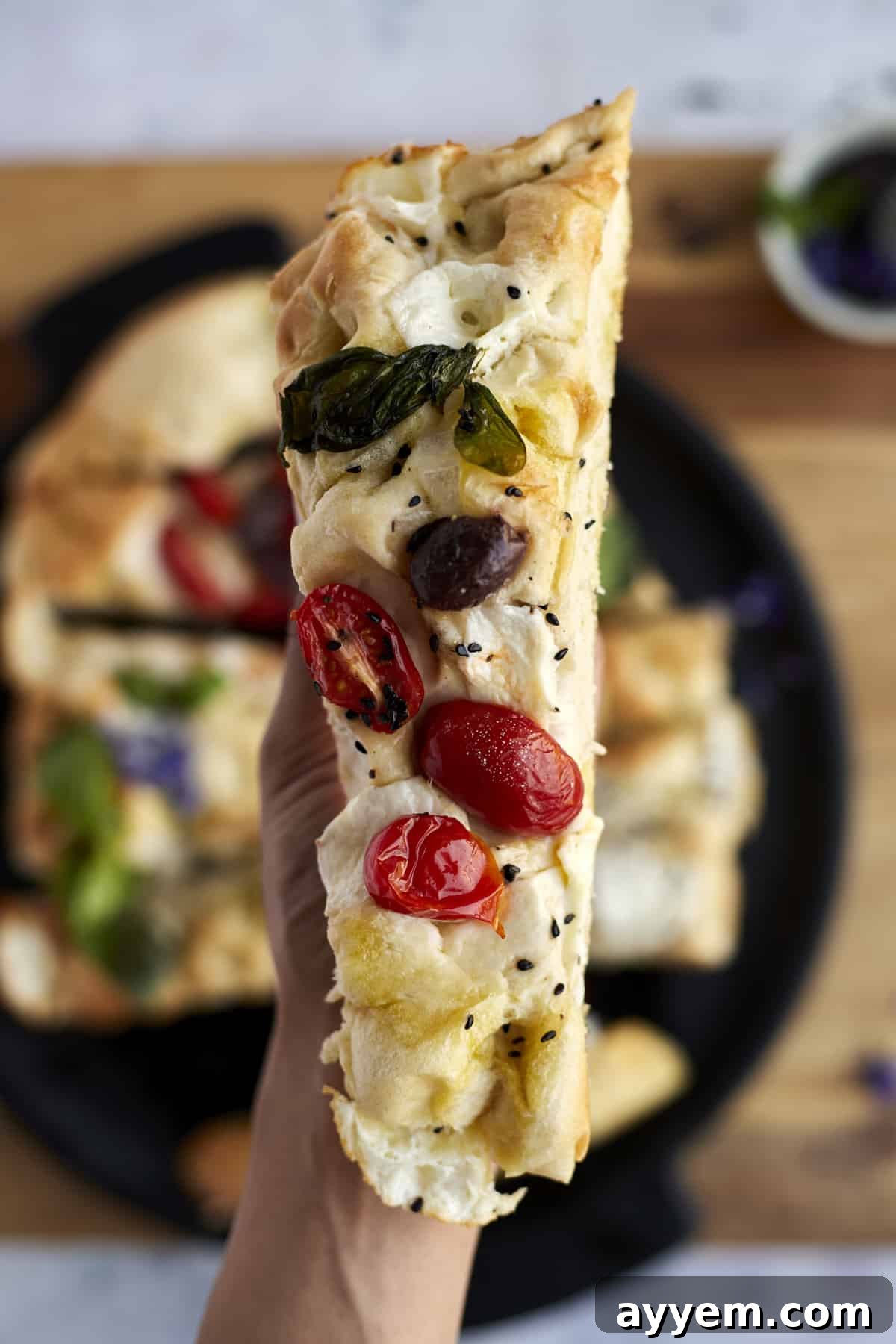 close up image of a slice of no knead focaccia bread art