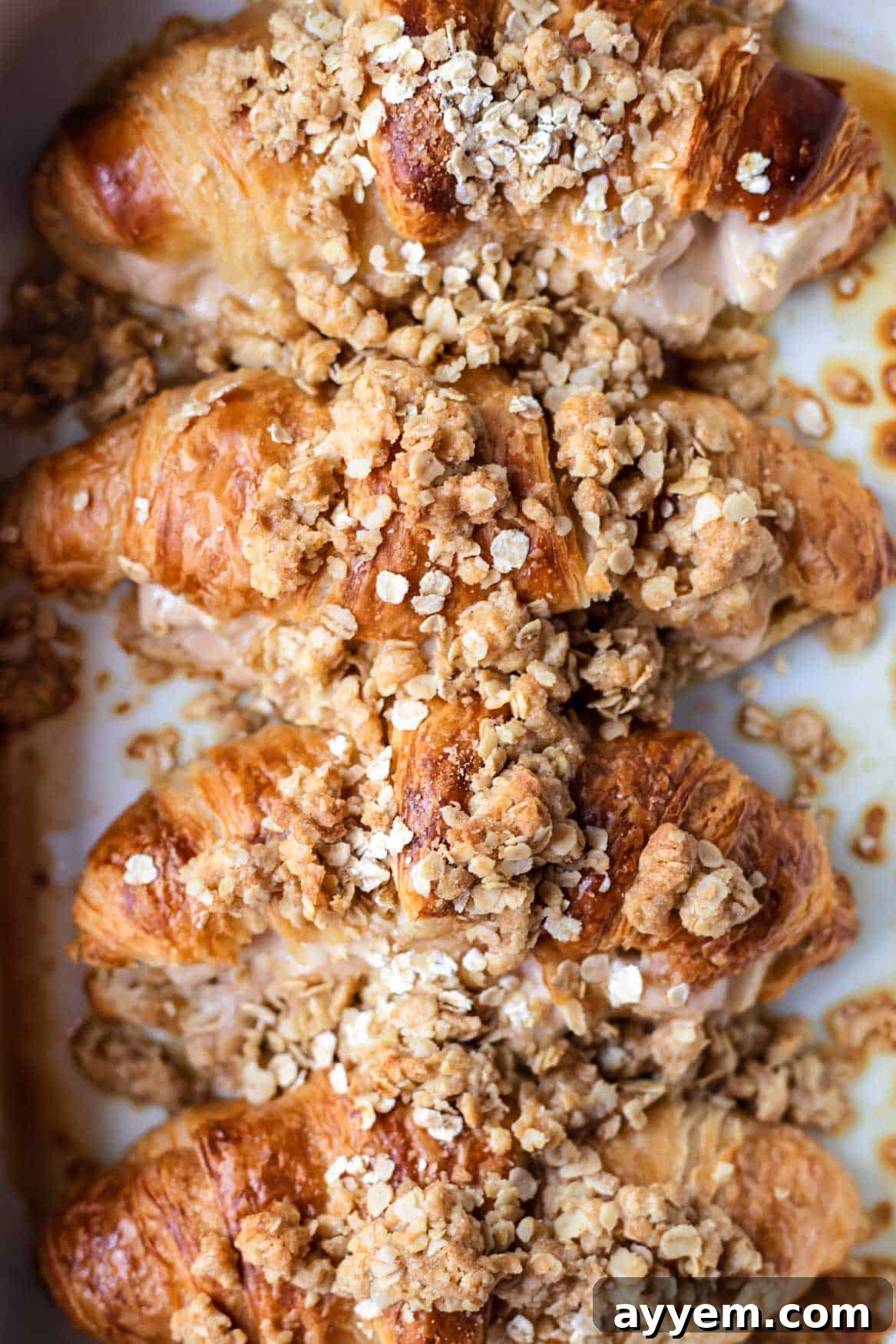 A close-up view of the baked cinnamon crisp apple french toast, showing the golden-brown crust and crisp topping.