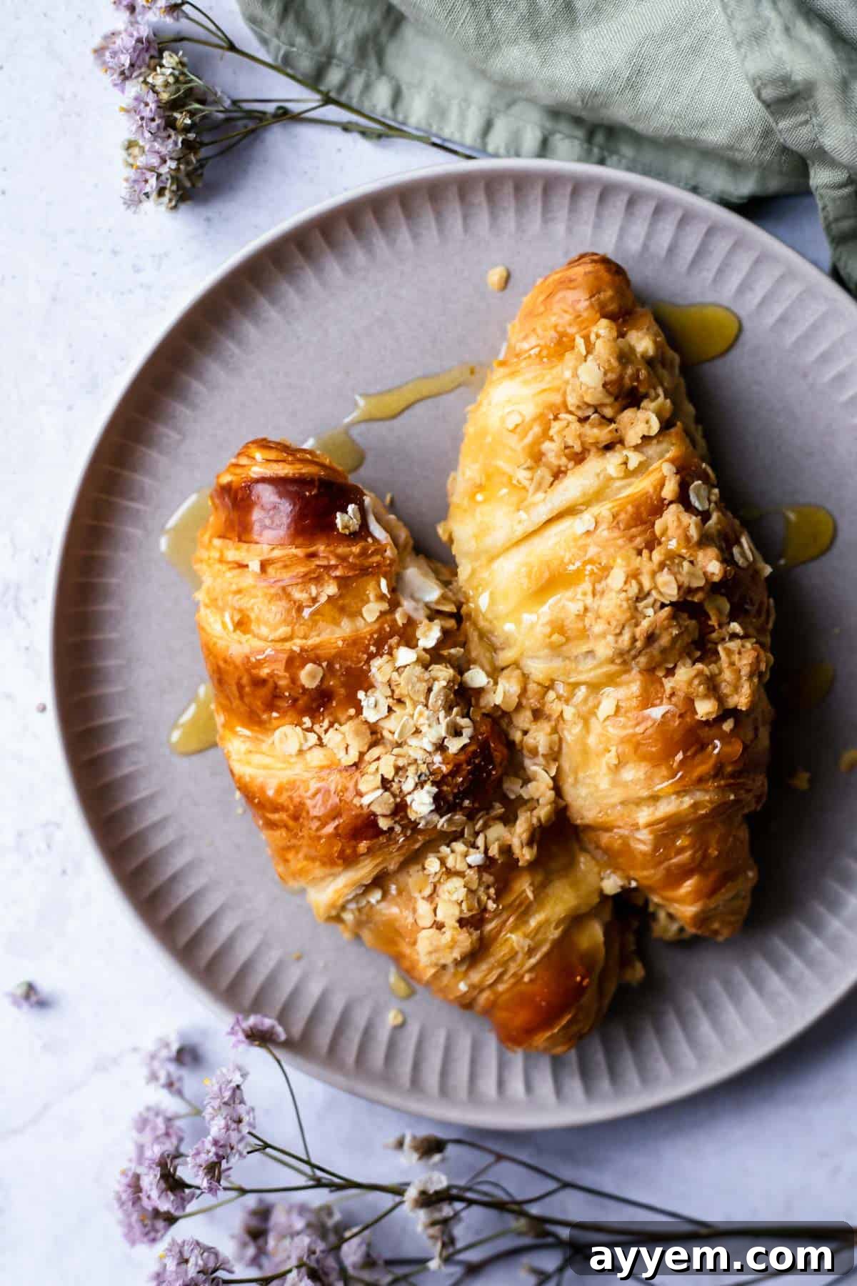 Two servings of cinnamon crisp apple french toast bake croissants on a plate, ready to be enjoyed.