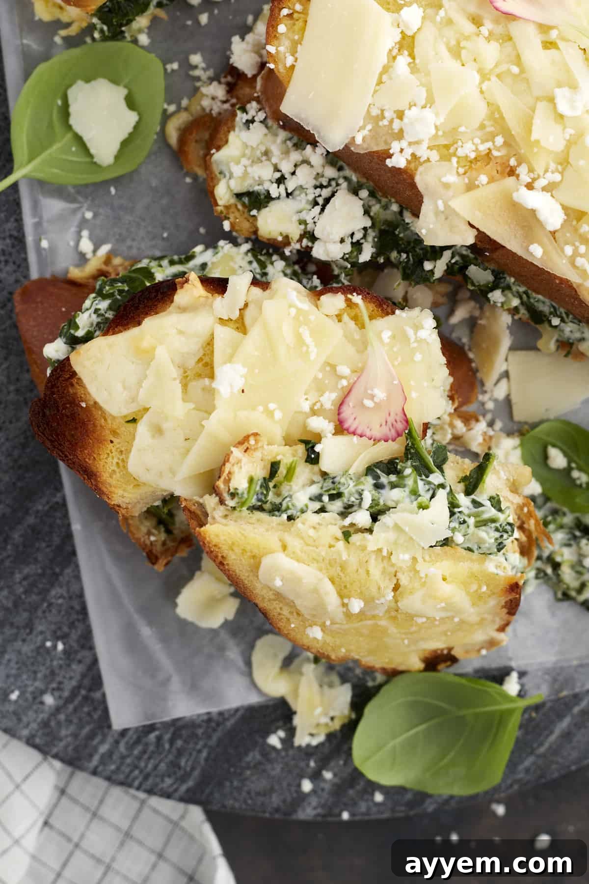 A vibrant close-up of Spanakopita-Inspired Spinach Grilled Cheese Sandwiches, golden and crispy, revealing a luscious, creamy spinach and cheese filling.