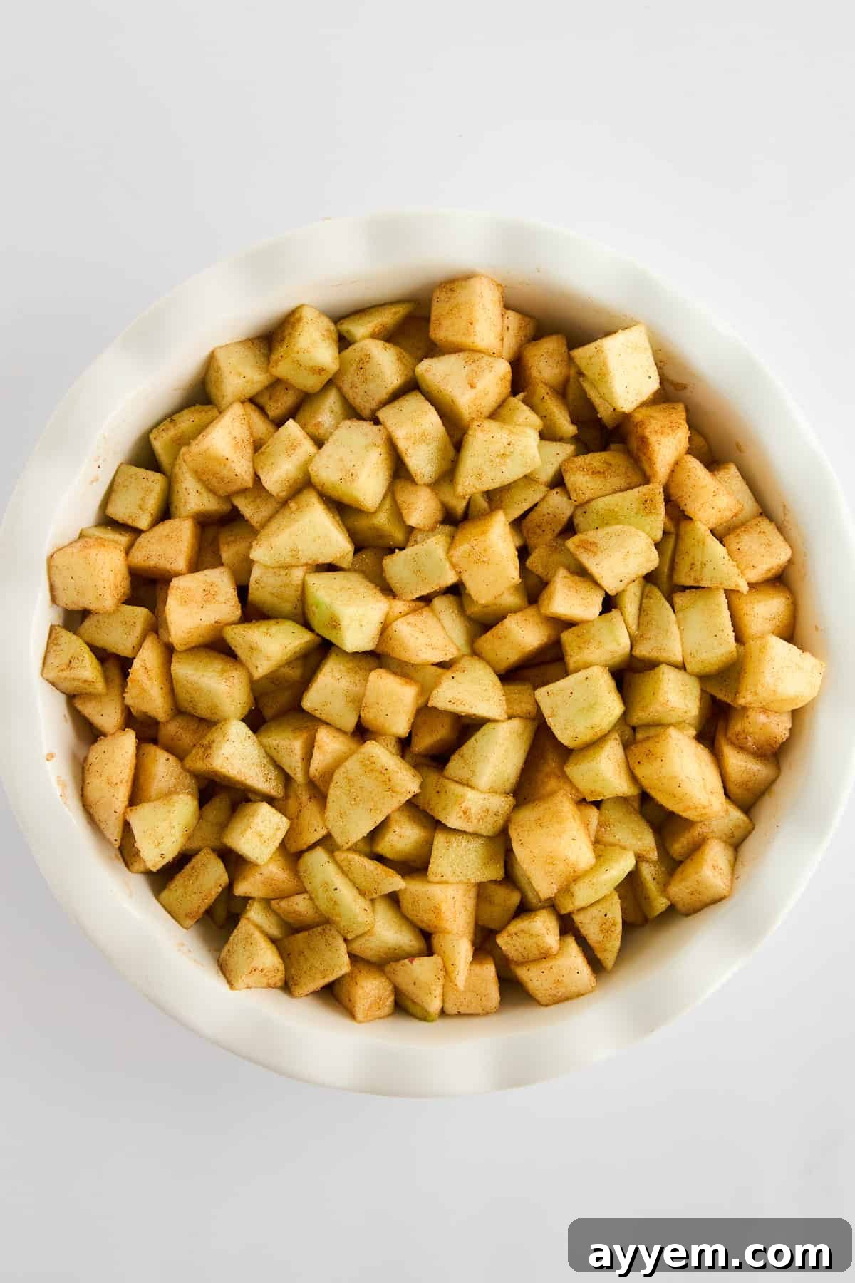 A bowl of neatly chopped apples, ready for the apple crisp filling.
