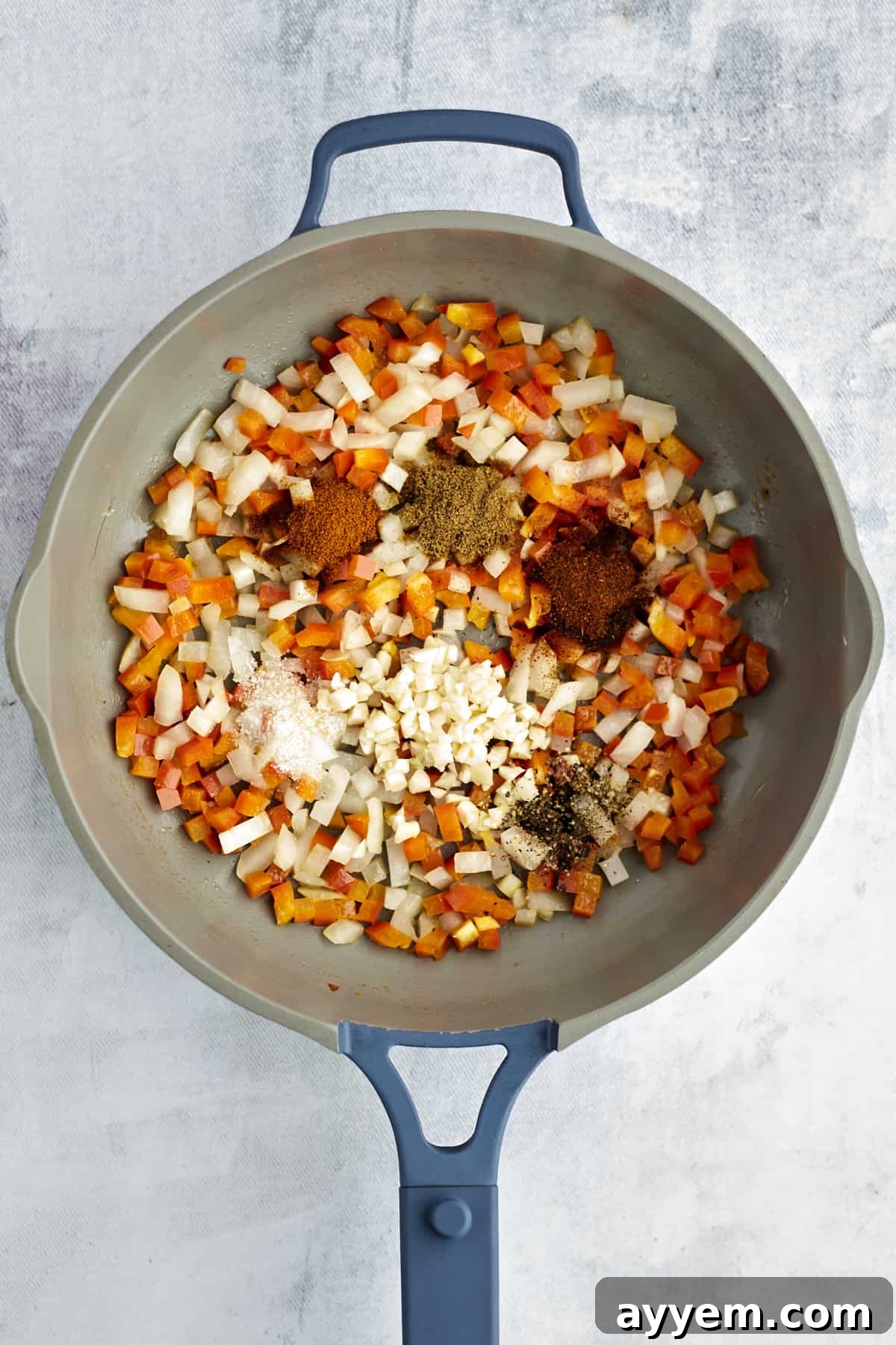 Feta Shakshuka Made Easy 4 Sautéed onions, bell peppers, and spices cooking in a large pot, creating an aromatic foundation.