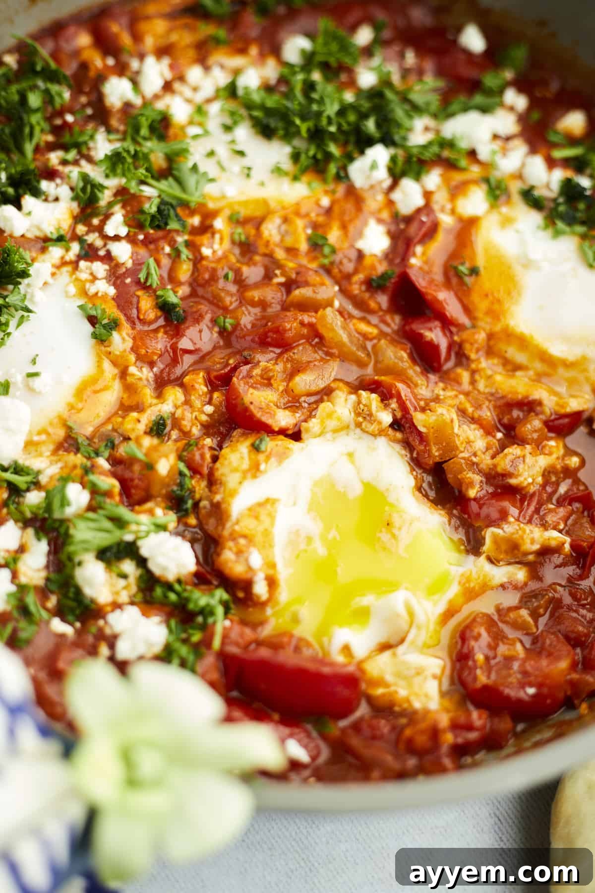 Feta Shakshuka Made Easy 10 A close-up view of a perfectly cooked easy shakshuka with feta, showcasing the rich sauce and egg yolks.