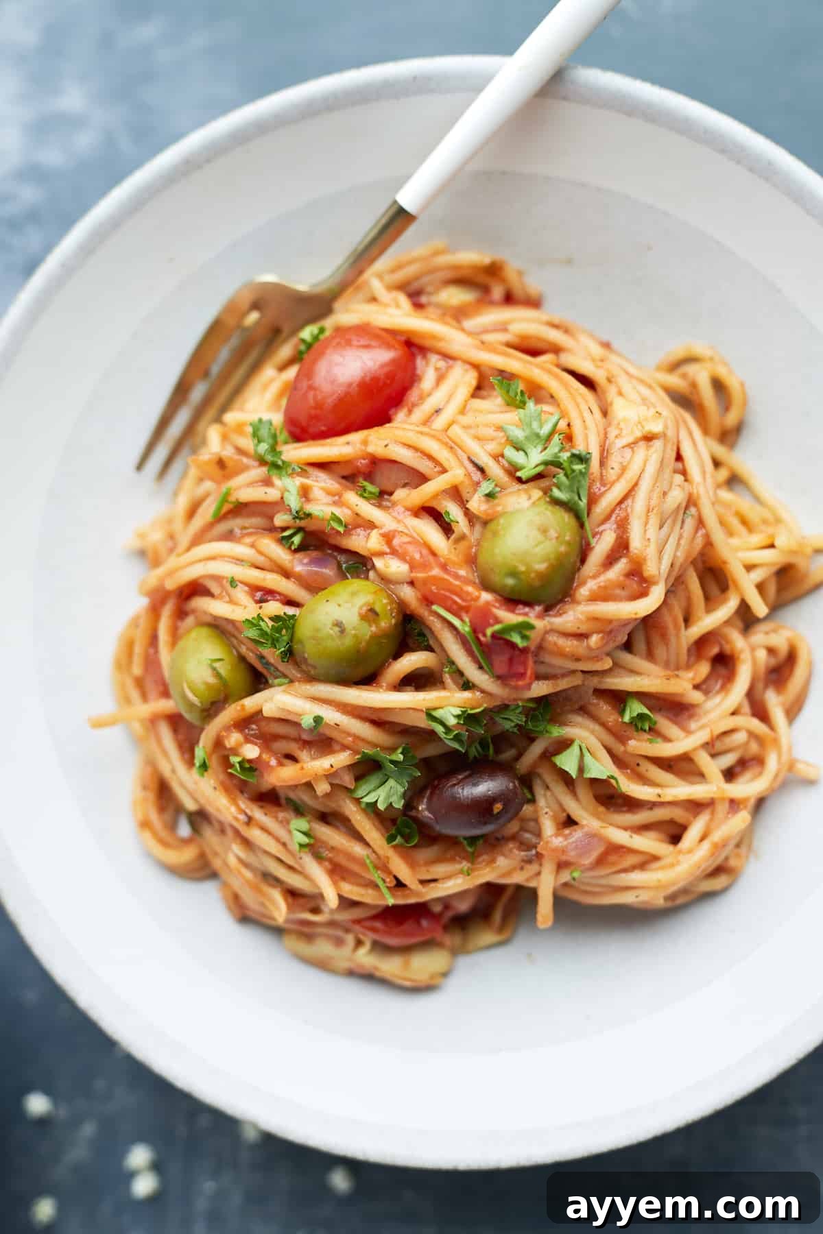 Plated greek spaghetti recipe with a fork on the side