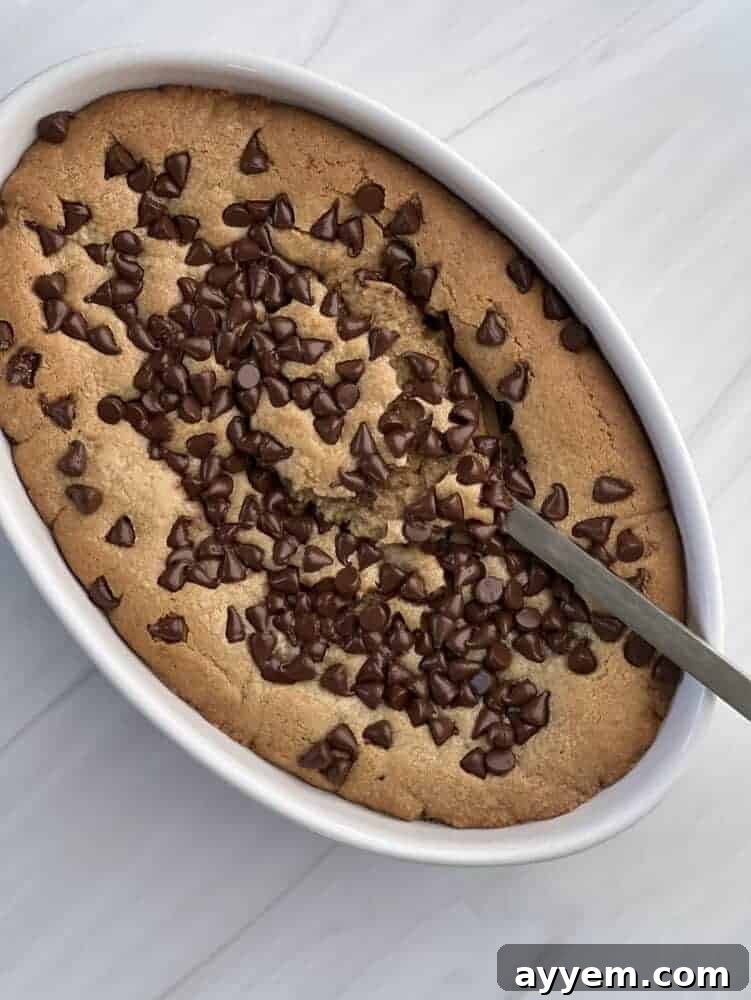 an inside out chocolate chip cookie with a spoon scooping out the center