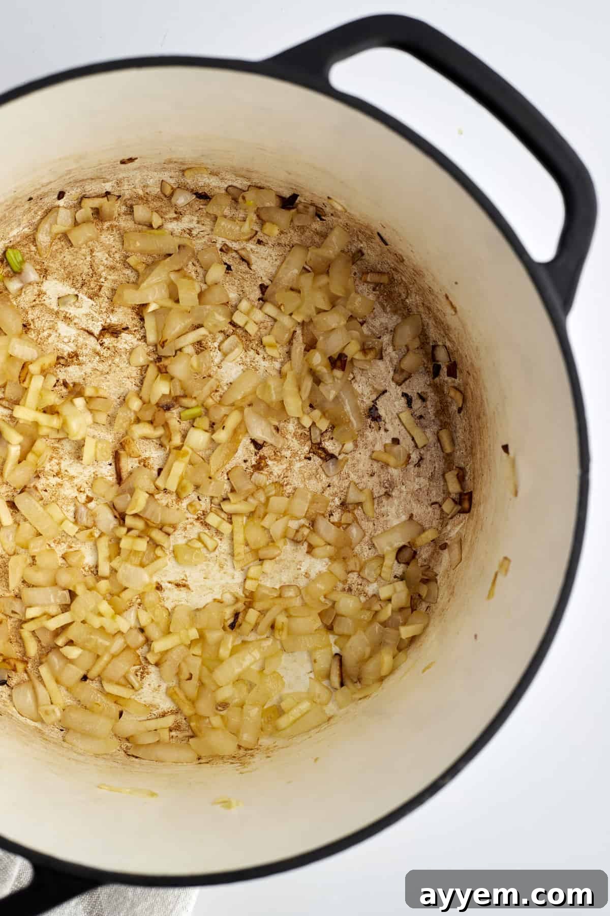 Sautéed shallots and garlic in a pot, forming the aromatic base for spicy rigatoni
