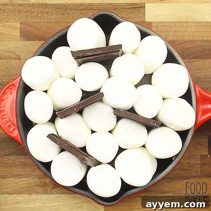 overhead image of a skillet full of marshmallows and chocolate to make peanut butter s'mores dip