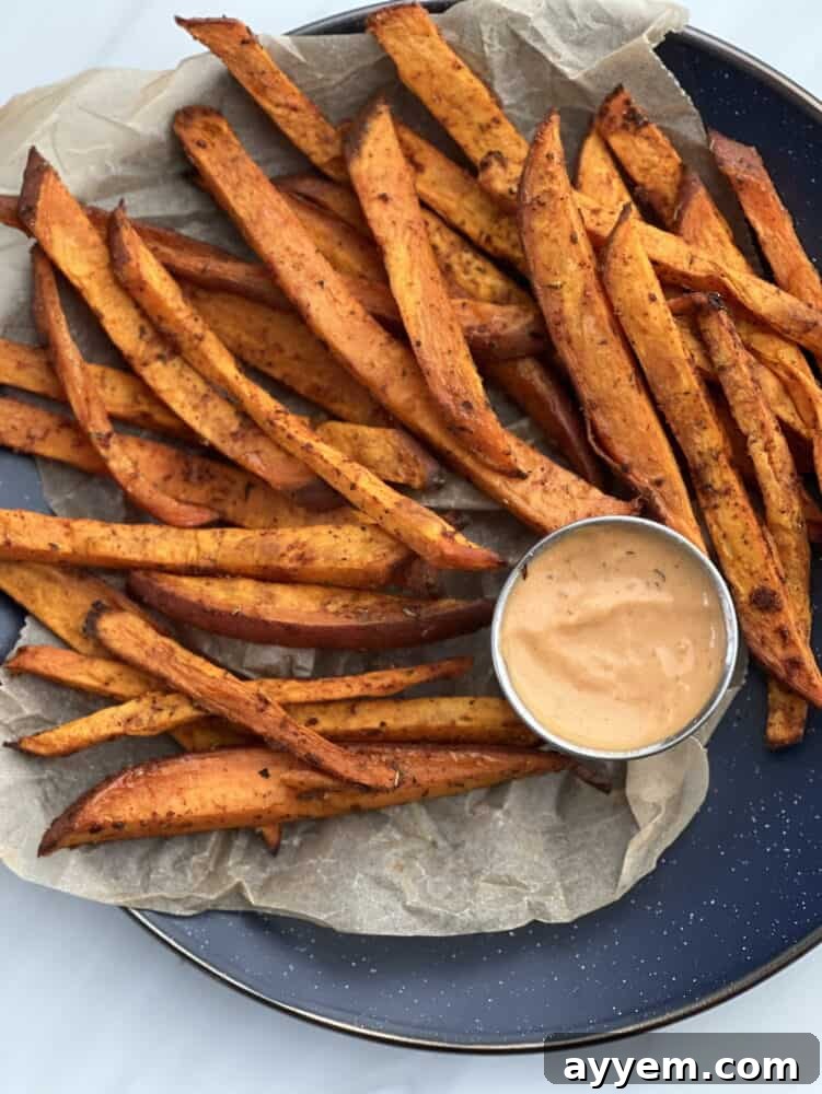 basket of sweet potato fries with a dip on the side