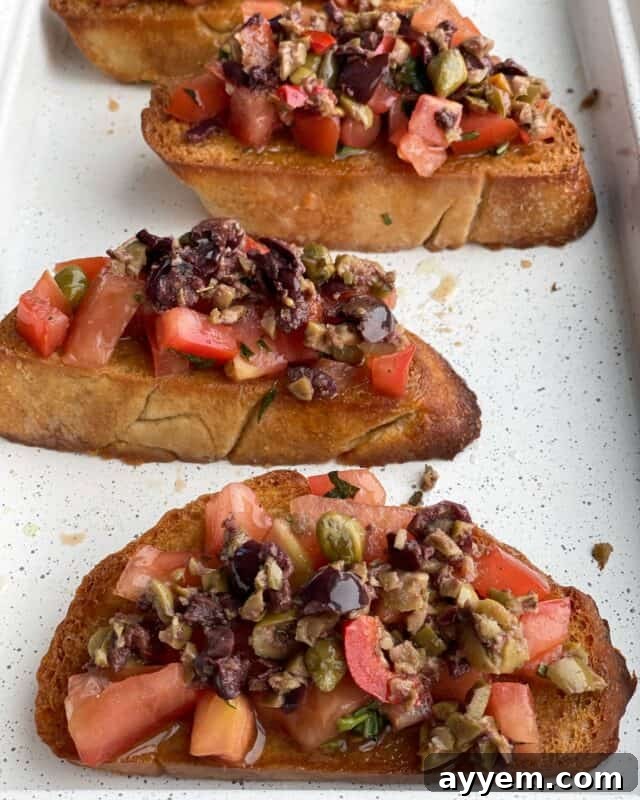 four pieces of olive tapenade bruschetta