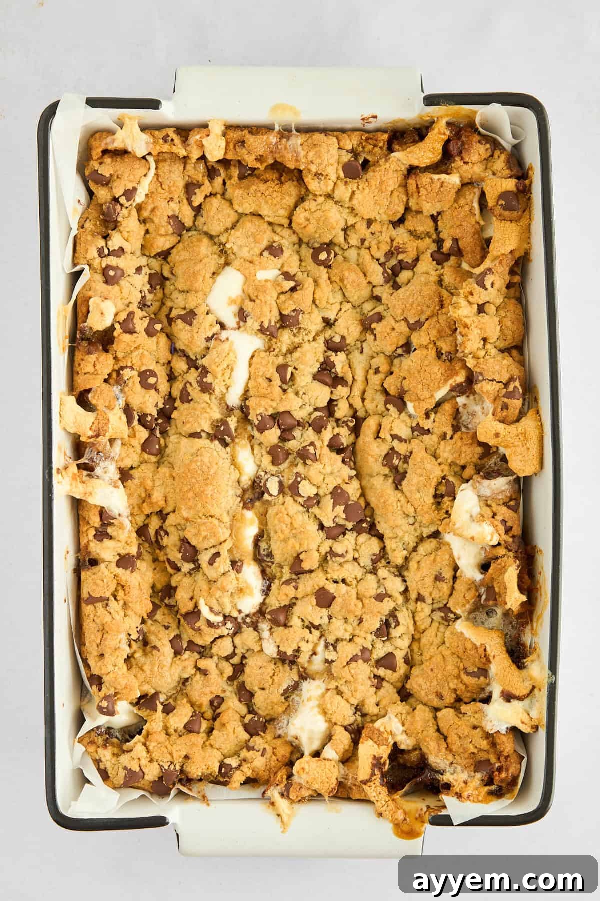 S'mores Brookie Bars with a visible layer of graham crackers and marshmallows before baking