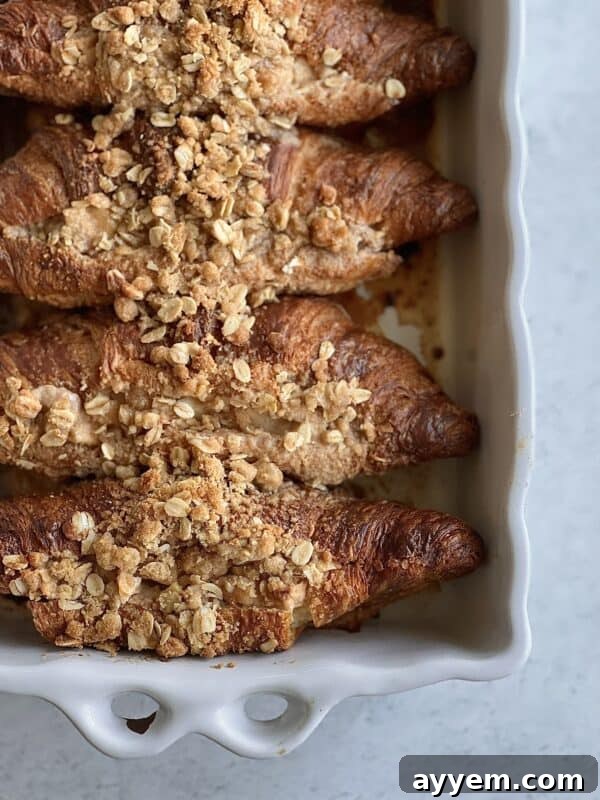 A warm dish of Apple Crisp Croissant French Toast, topped with a golden crumble and ready to be served.