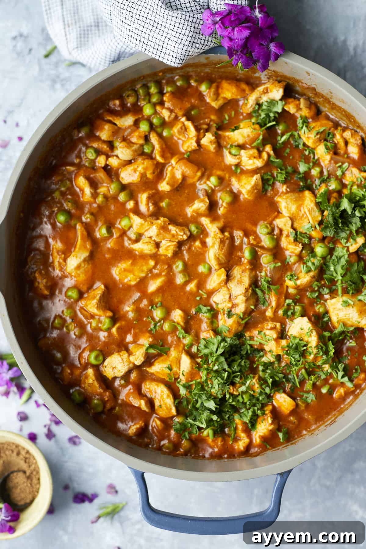 Overhead shot of creamy Madras Curry Chicken simmering in a pan, ready to be served.