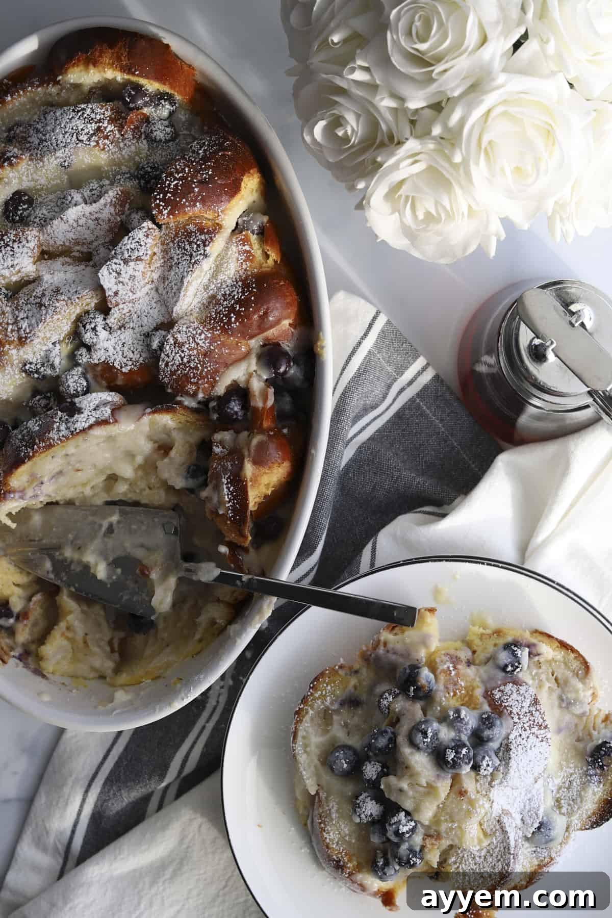 overhead blueberry mascarpone french toast baking dish and plated with powdered sugar 