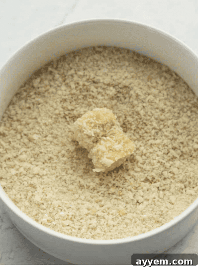Mashing potatoes with sour cream, cheese, and seasonings.
