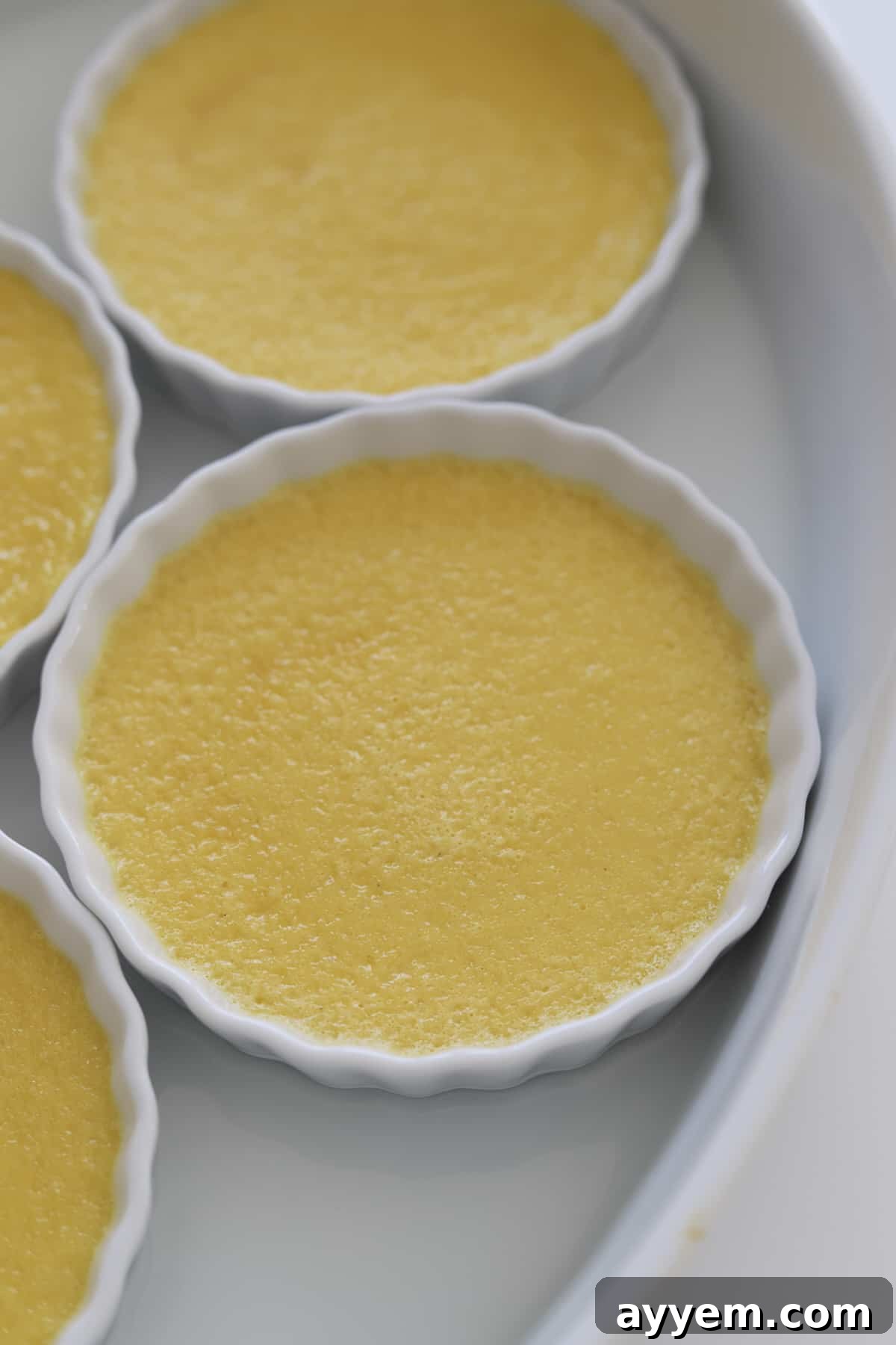 Espresso Infused Crème Brûlée 4 ramekins of creme brûlée in a water bath