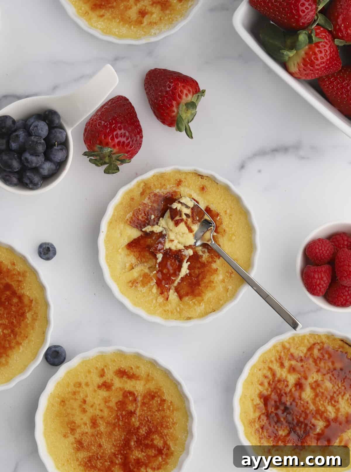 Espresso Infused Crème Brûlée 9 creme brûlée ramekins with a spoon dipping into one