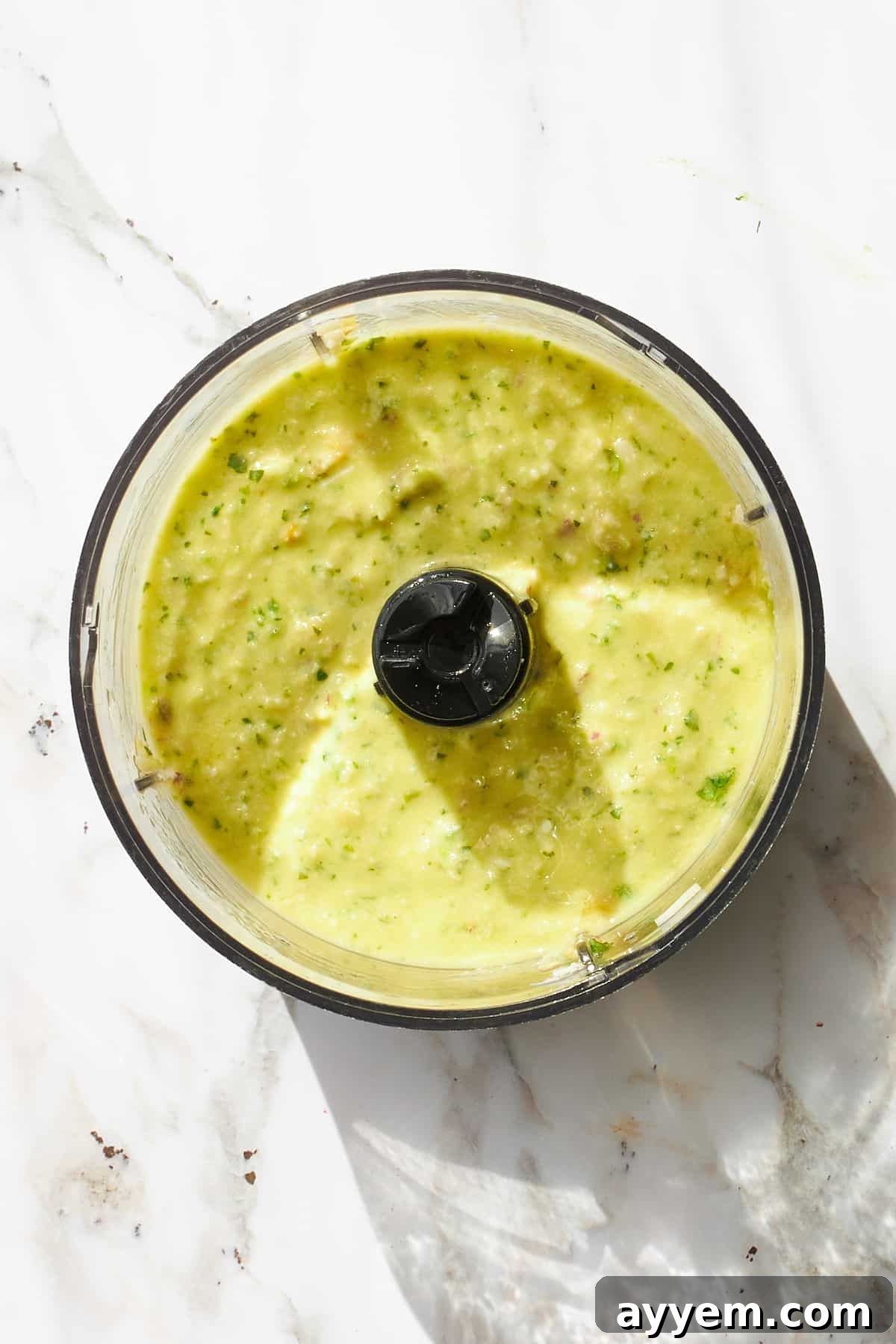 Blended green goddess dressing in a food processor. 