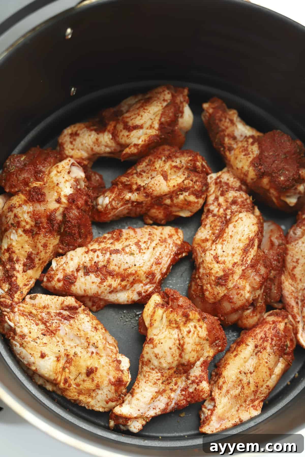 raw seasoned chicken wings in an air fryer