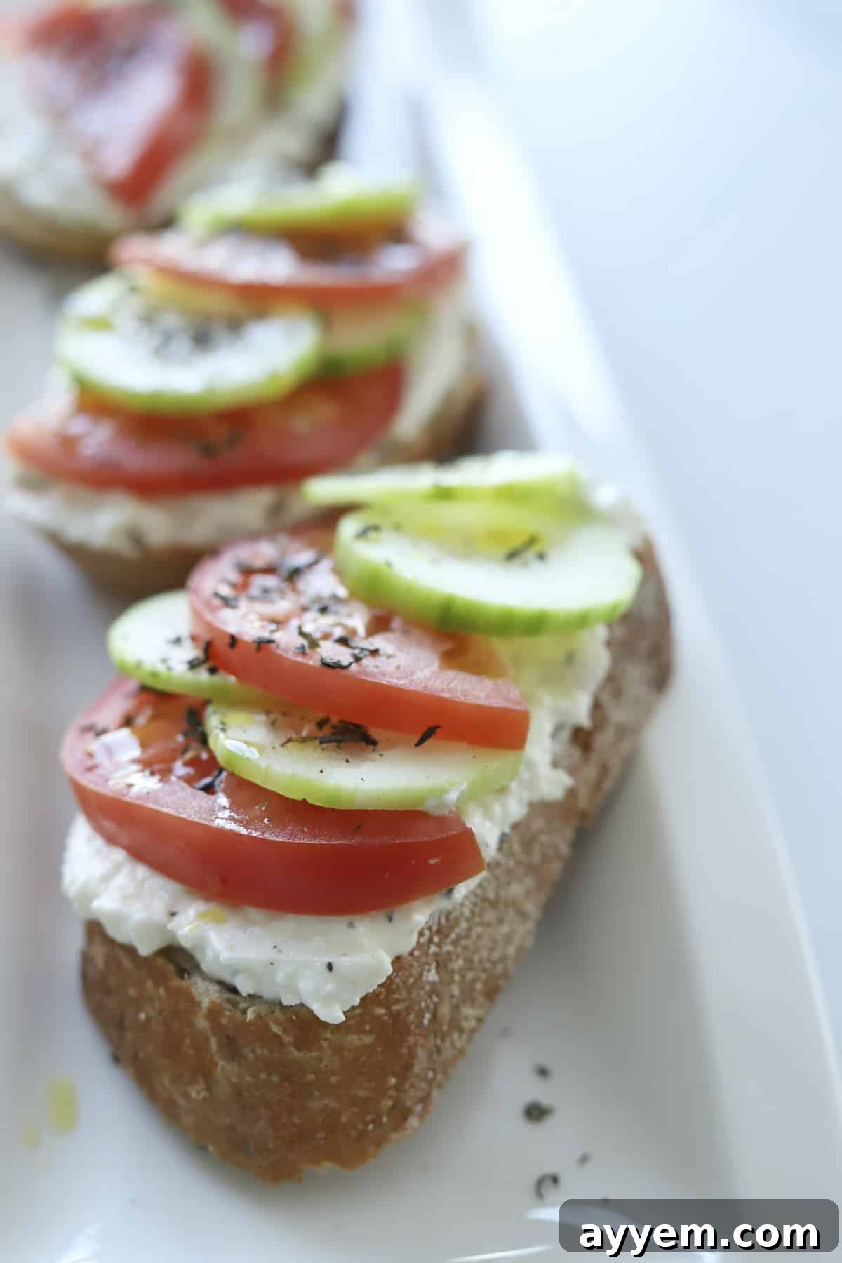 closeup baguette with feta, tomatoes, and cucumbers 