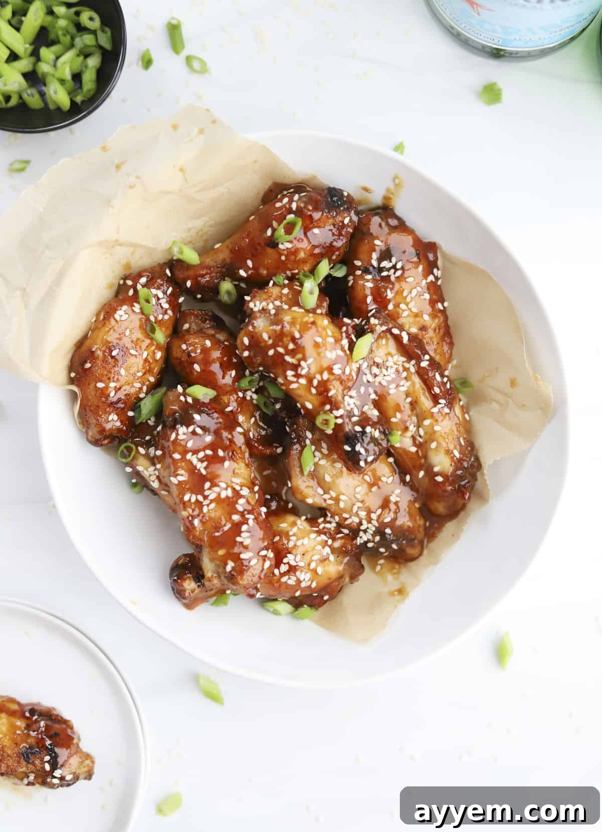 A large bowl brimming with golden-brown air fryer honey garlic chicken wings, perfectly glazed and ready to serve.