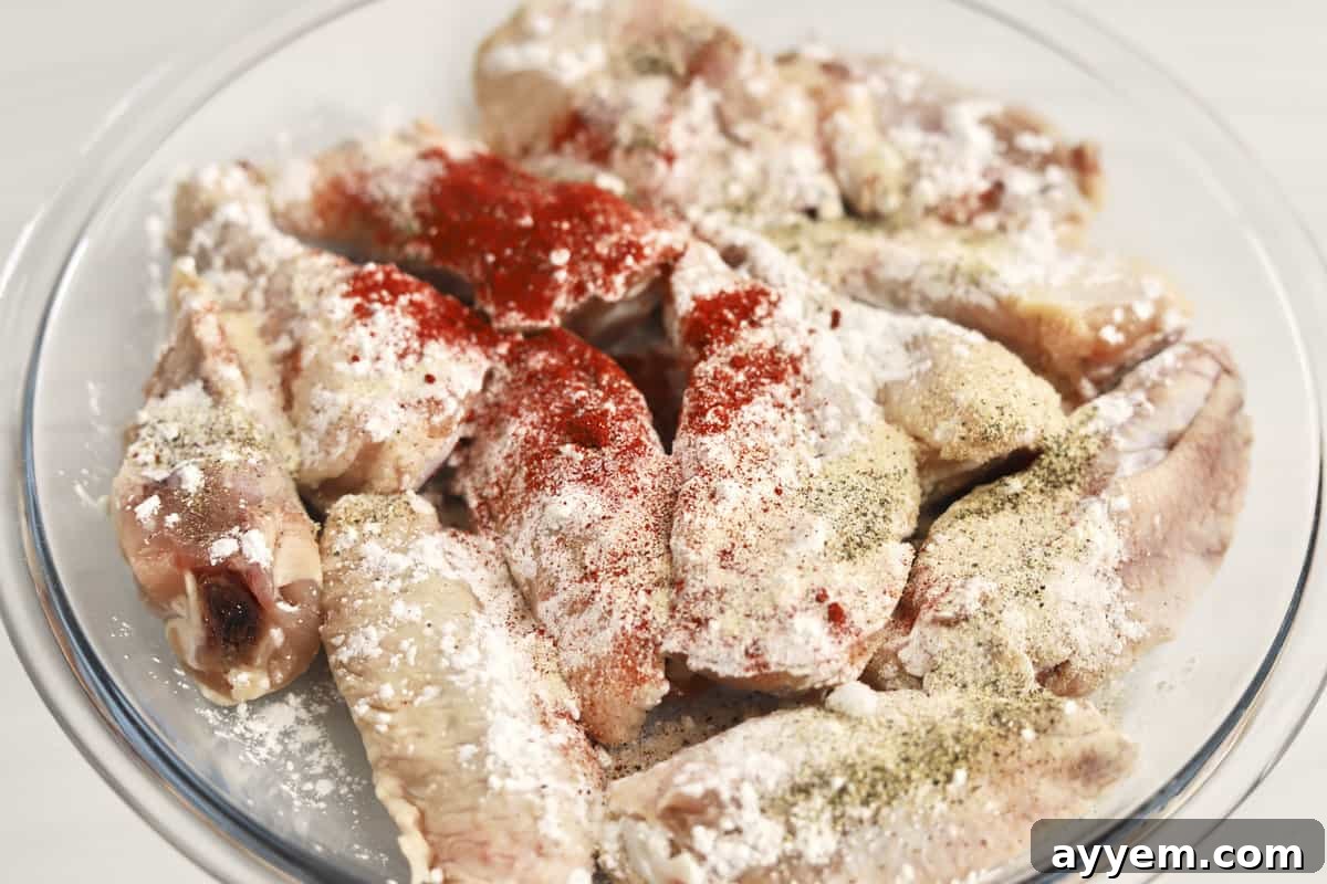 Chicken wings coated in seasoning and cornstarch, ready for the air fryer.