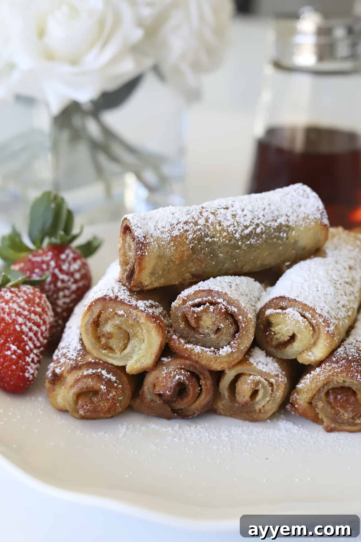 plate of cinnamon roll french toast with strawberries