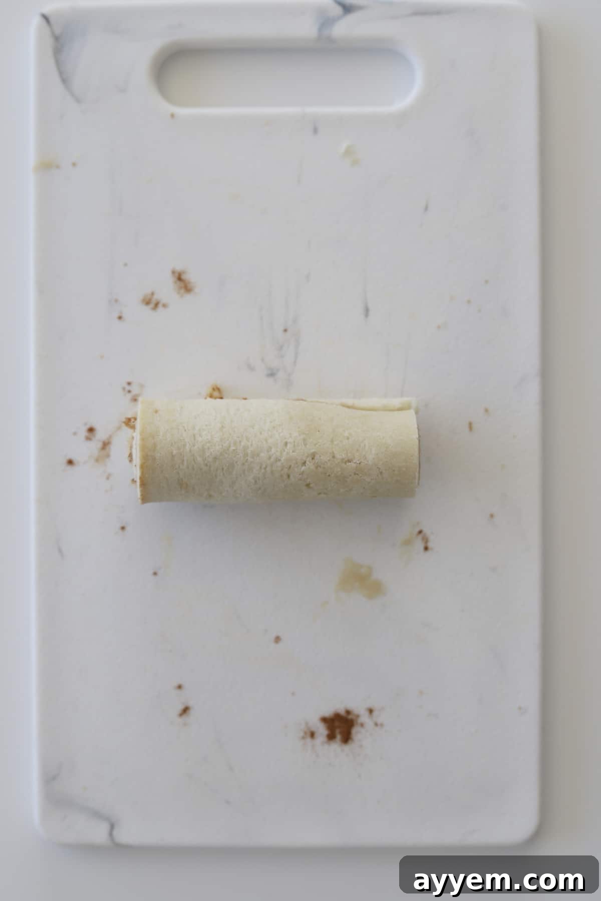 an uncooked cinnamon roll french toast roll up
