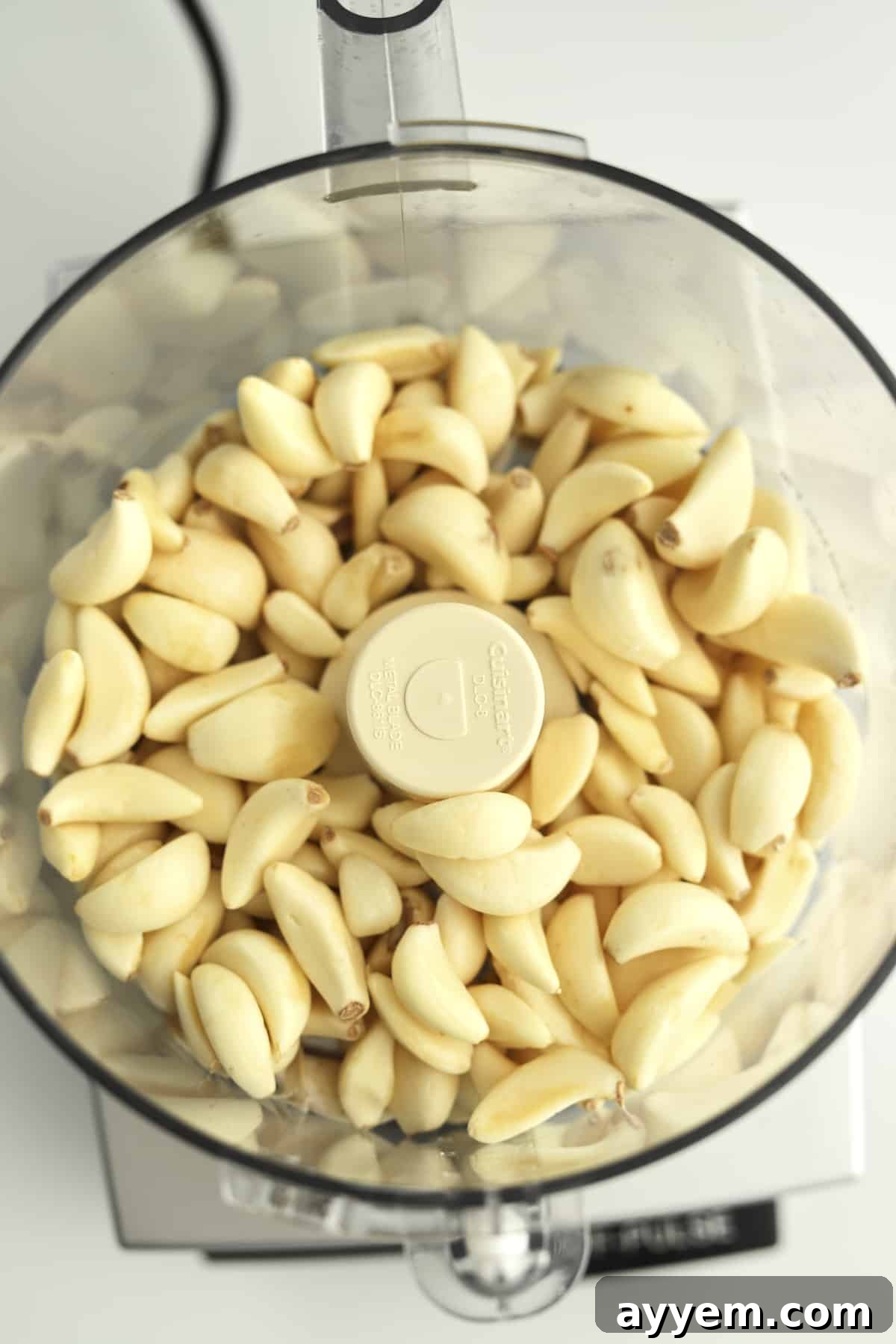 Fresh garlic cloves ready for processing, highlighting the initial step in preparing garlic for various storage methods to extend its freshness.