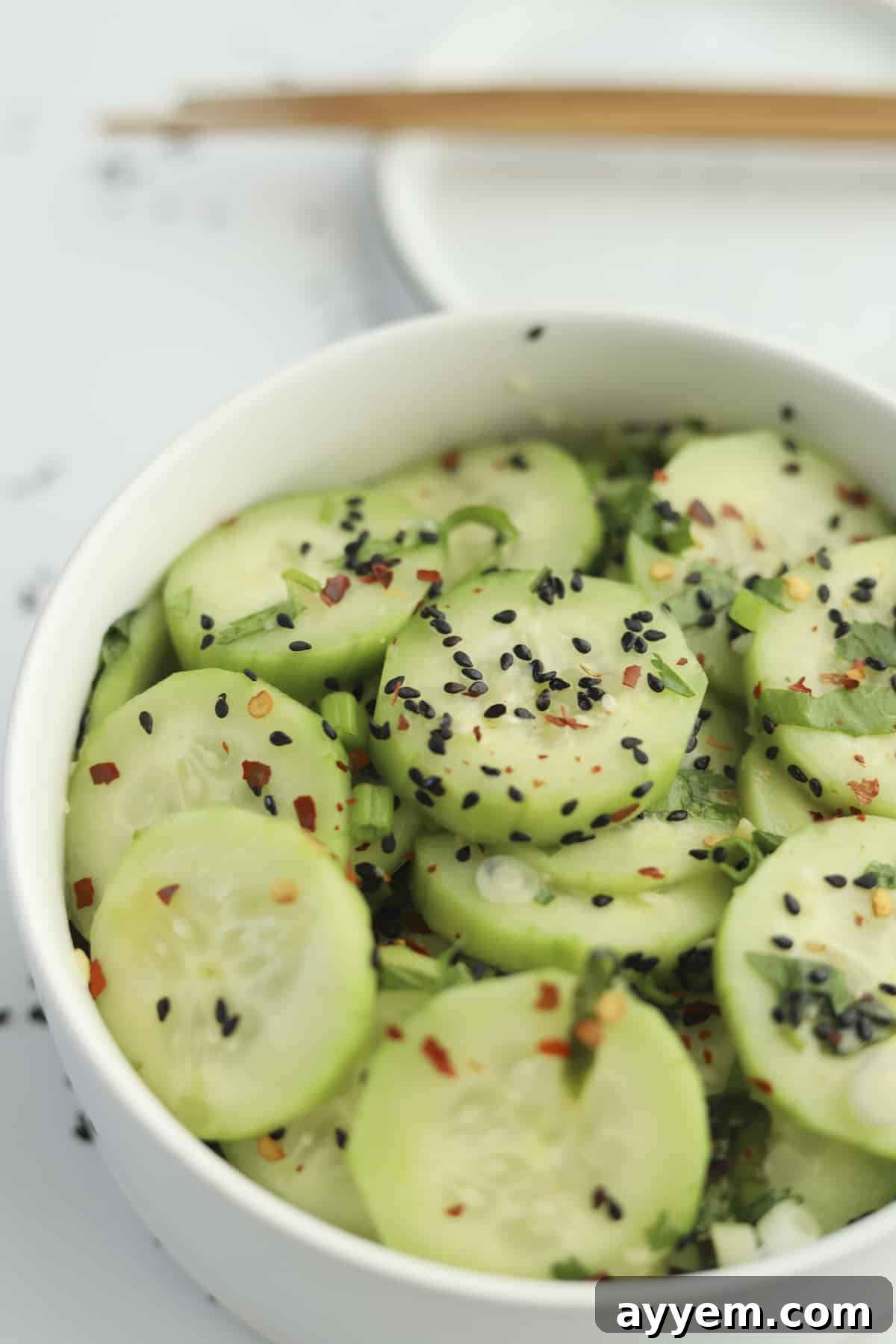 sideview of cucumbers with black sesame seeds. 