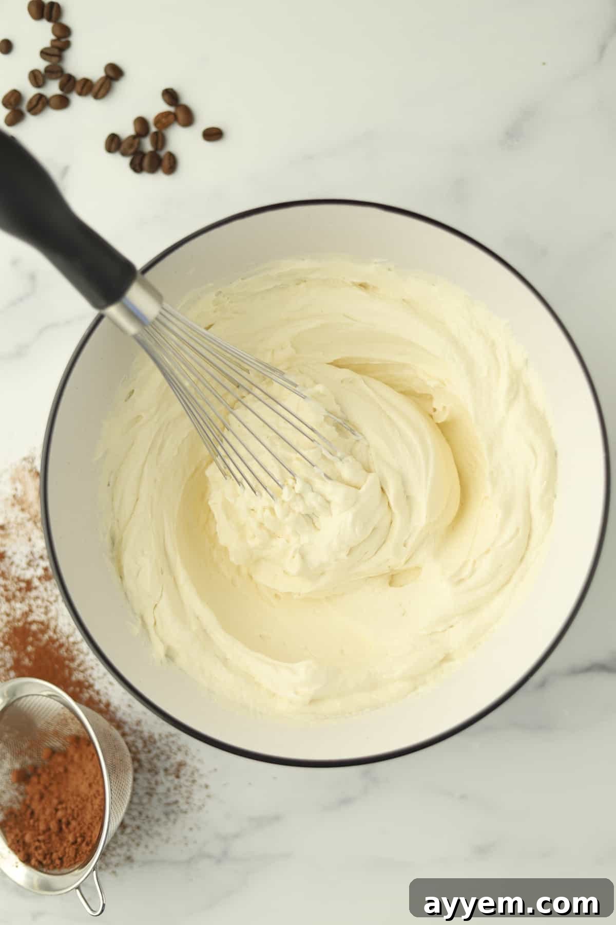 A bowl filled with freshly whipped mascarpone cream, smooth and inviting.