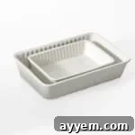 Two white ceramic baking dishes, essential for baking this mac and cheese.