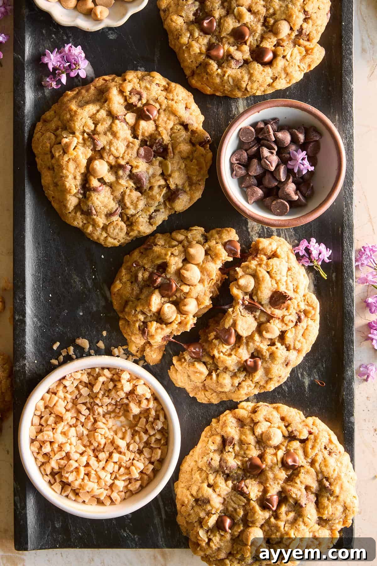 A beautifully arranged platter of freshly baked copycat Crumbl Mom's cookies, glistening with a sprinkle of sea salt.