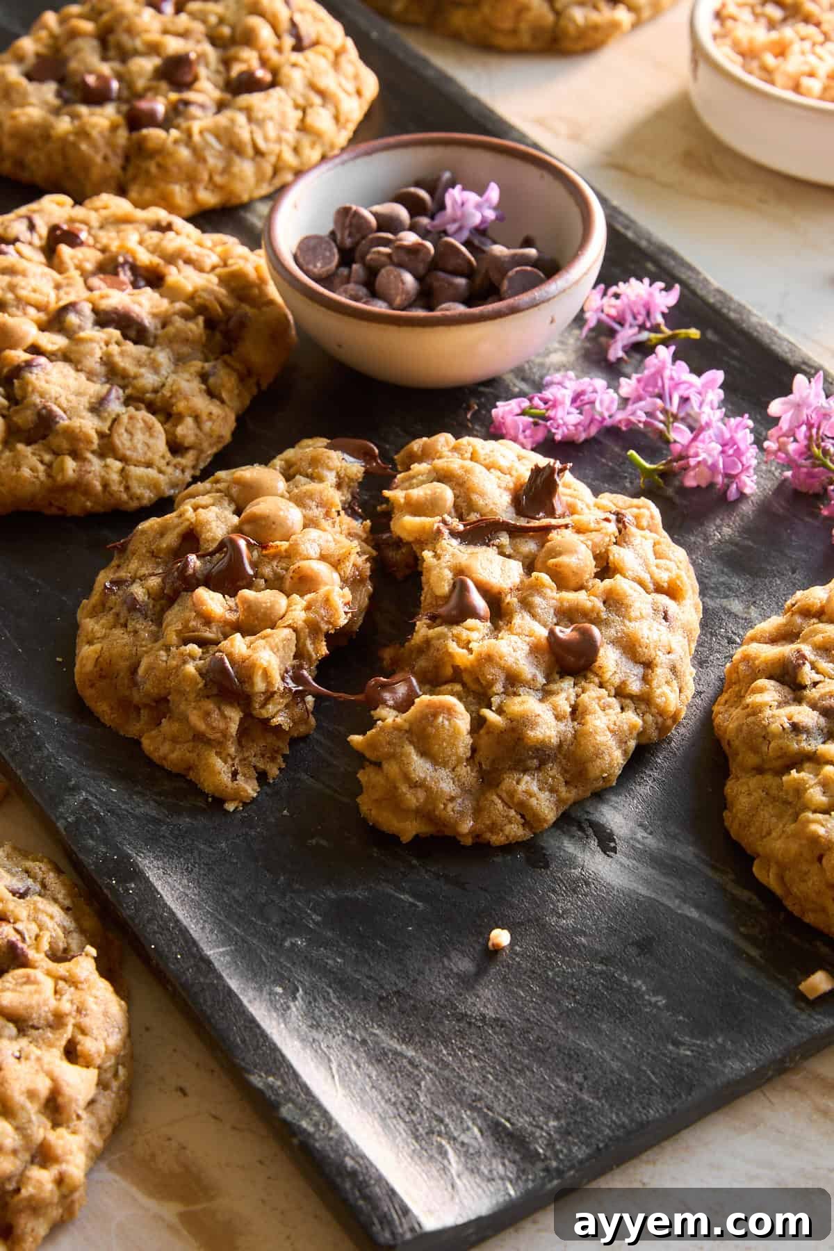 A platter of copycat Crumbl mom's cookies with one split in half.