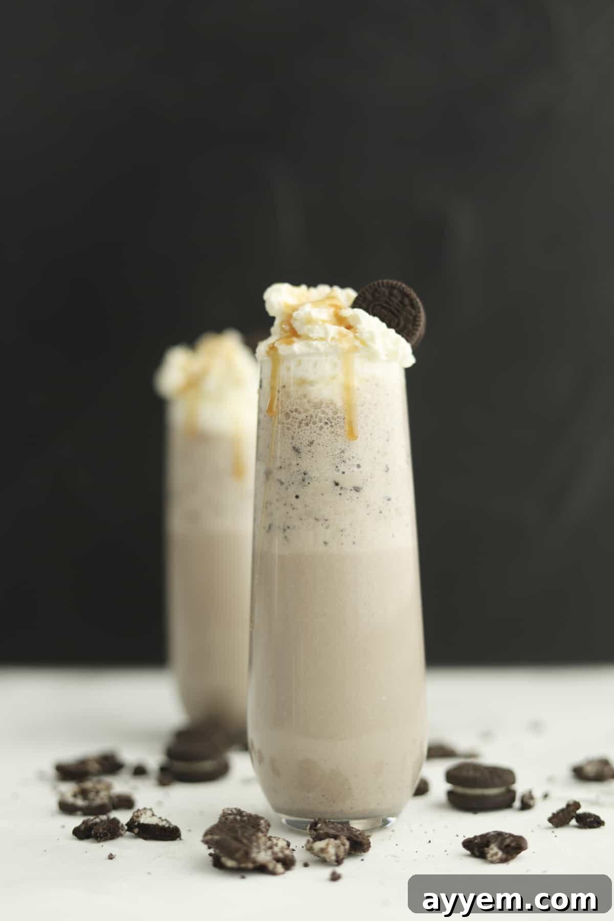side view of oreo frappuccino with caramel dripping down the side and straw