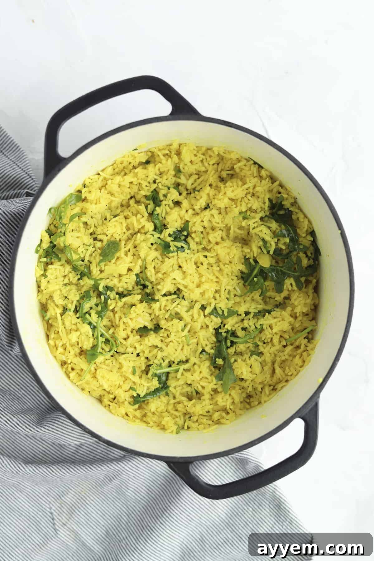 A beautifully presented bowl of Coconut Turmeric Rice with fresh garnishes