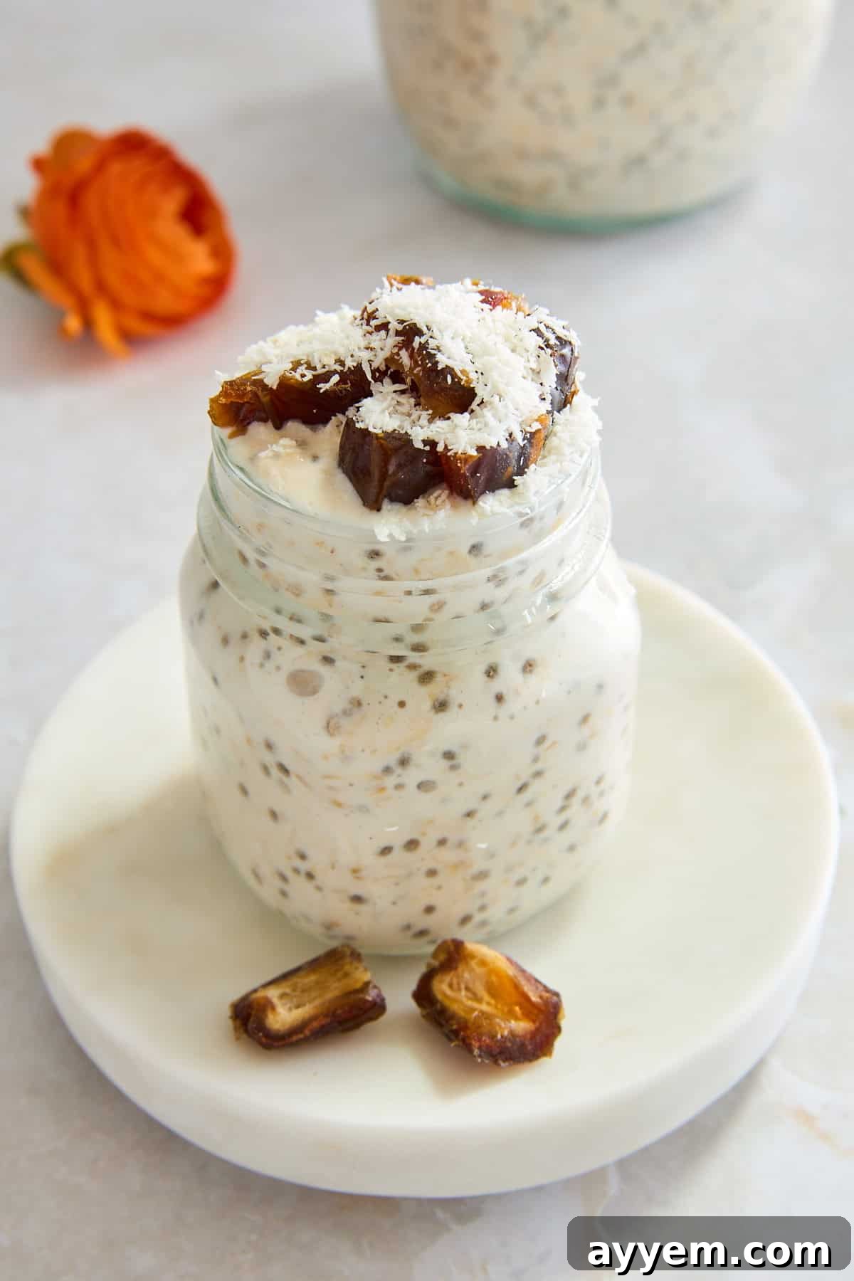 Close-up of a jar of Date and Apricot Overnight Oats, showing the creamy texture and pieces of fruit.