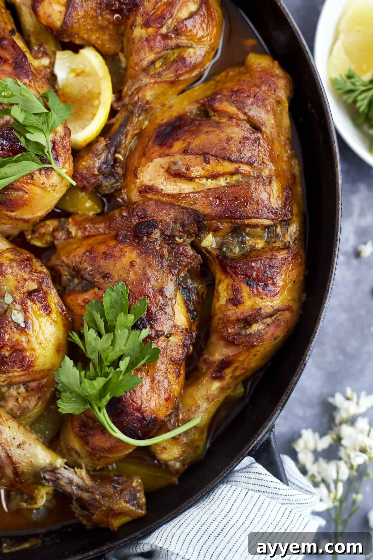 A large serving of Middle Eastern chicken and potatoes, garnished with fresh herbs, ready to be enjoyed.