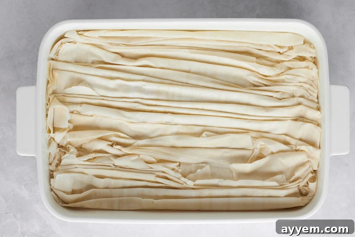 Crinkled sheets of phyllo dough in a baking sheet.