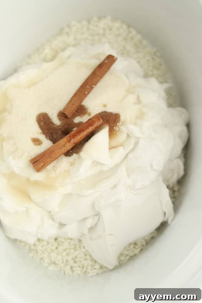 rice, coconut cream, sugar, vanilla, and cinnamon sticks in a slow cooker