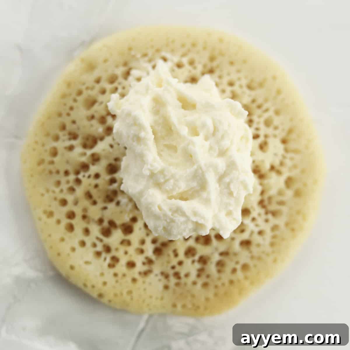 atayef dough with a dollop of cream cheese in the center