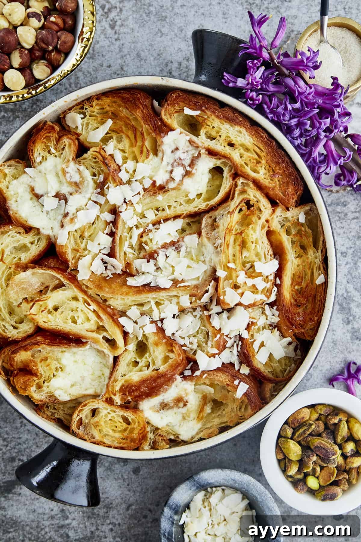 overhead image of a pan of yawmiyat om ali topped with coconut flakes