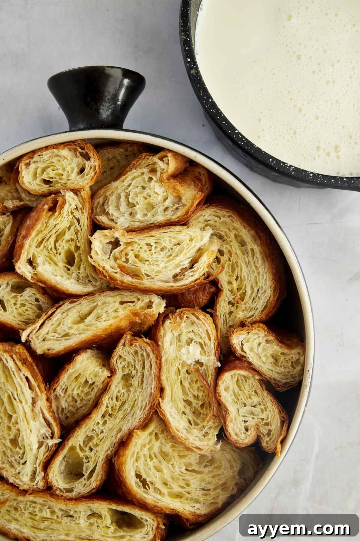 cubes of croissants in a single layer in a baking dish