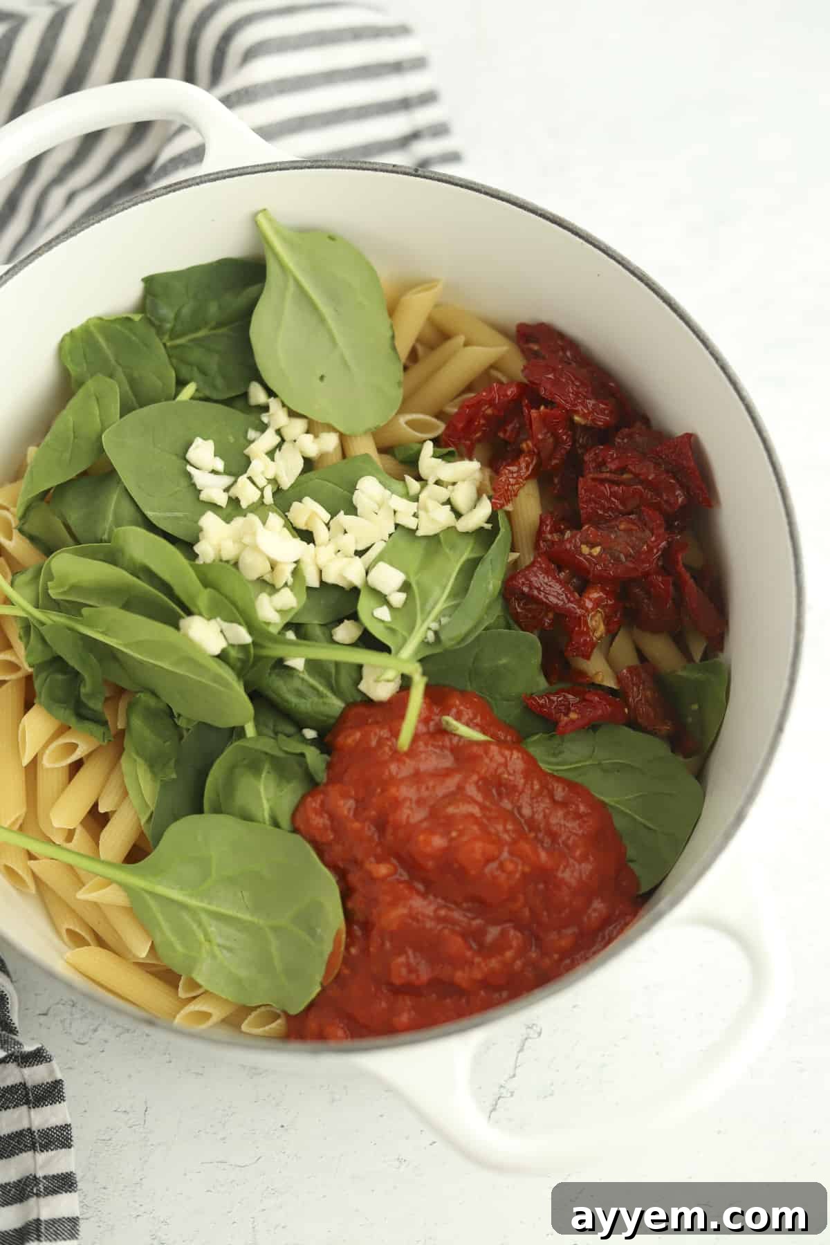 pot of penne with spinach, garlic, and marinara